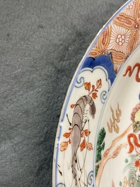 A Chinese famille verte dish with a carp surrounded by horses and buddhist lions, Kangxi